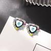 Zhou Yutong con aretes de amor esmaltados retorcidos con diamantes de color, aretes para niña, marea, corazón brillante, aguja de plata S925