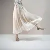 Saia de Gaze com Brilho de Seda Estilo Novo 2026 para Mulheres Primavera e Verão Brilho Metálico Saia Evasê Emagrecimento e Fluidez Comprimento Médio Estilo Elegante