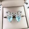 Exquisitos aretes de botón con forma de corazón y moño con microincrustaciones de pequeños diamantes de imitación brillantes Azules de diamantes completos Aretes simples de rábano de fácil combinación