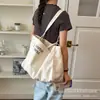 Bolsa de lona con estampado de letras para mujer, nuevo modelo 2026, gran capacidad, bolso de hombro simple y artístico, bolsa para el trabajo