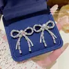 Pendientes de flor con lazo de circonita y pasador de plata 925, pendientes transfronterizos elegantes de lujo ligero, pendientes de perlas modernos y elegantes para mujer