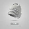Bestseller transfronterizo de invierno: gorro tejido grueso con forro de polar y pompón, gorro clásico de punto trenzado versátil, gorro de lana de color liso a la moda