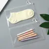 En stock bolsa con cierre de cremallera y lengüeta de PE transparente bolsa autosellable de plástico con anillo redondo esmerilado bolsa de almacenamiento de alta transparencia apertura autosellable empaque