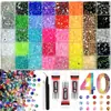 Caja de 24 compartimentos moderna y popular de diamantes de resina jelly de color AB con base plana, empaquetada para arte de uñas DIY, accesorios pequeños, venta al por mayor