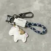 Accesorios en Stock: Llavero Creativo para Coche con Diseño de Bolsa de Dinero, Anilla de Figura de Ocho, Cuerda Trenzada de Cuero