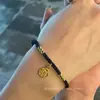 Venta al por mayor de fábrica pulsera chapada en oro marca Fucai cuerda negra roja cuerda de mano para amantes pulsera de cuentas de transferencia de este año marea nacional