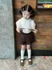 Conjunto de verano para niña estilo coreano 26 modelo nuevo, camisa de manga corta plisada estilo universitario para niña pequeña con shorts de encaje