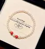 Pulsera elástica de estilo chino con perlas Shijia perfectamente redondas y espaciadores de cinabrio imperial para mujer, Pulsera elástica retro de alta gama única