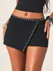 Pantalones falda asimétricos con tachuelas Y2K de venta caliente transfronteriza europea y americana para mujer, pantalones cortos ajustados de tiro bajo, efecto de dos piezas, que realzan la cadera