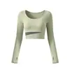 Conjunto de yoga de dos piezas de alta gama en bloques de color para mujer, cuello redondo, top corto de manga larga, pantalones tipo falda de doble capa con cintura cruzada, deportivo