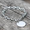 Venta al por mayor directa de fábrica pulsera de moda lisa redonda de acero de titanio para mujer y hombre pulsera de acero inoxidable redonda con marca