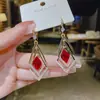 Nuevos pendientes de borla larga de alto temperamento para mujer, nuevos pendientes de botón de lujo ligero, joyería para orejas de estética fría nicho ins para mujer