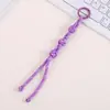 Encanto de bolsa creativo y moderno de nudo de botón, un accesorio de bolsa único y versátil tejido a mano con cuerda de nylon, también adecuado para colgar teléfonos