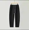 Calça Cropped Masculina da Moda Outono com Listras Verticais Calça Casual para Casal Modelagem Solta Versátil Calça Banana Cor Sólida Calça de Moletom Masculina