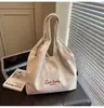 Bolso Texturizado Estilo Coreano Transfronterizo Estilo Perezoso 2025 Nuevo Gran Capacidad Casual Invierno Rayado Bordado Bolso de Hombro