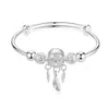 Directo de fábrica Moda japonesa y coreana Pulsera hueca con campana Atrapasueños Pluma Hebilla de presión y extracción de plata Pulsera ajustable Venta al por mayor