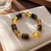Pulsera Mingtai Jewelry de Cristal Blanco Ojo de Tigre con Oro Negro Super Siete Ágila Súper Siete Natural