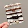 Nuevas diademas de alta gama 2026 para mujer, ligas de goma, cordones para el pelo, anillos para el pelo, cubiertas de cuero, accesorios para el pelo de niña con un toque de sofisticación