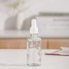 Venta al por mayor de fábrica botella de aceite de vidrio botella gotero con cabezal de arena botella de spray transparente botella de cosméticos portátil