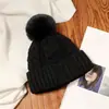 Gorro de punto rojo para mujer 2026 nuevo estilo viaje Sichuan-Tíbet protección cálida para los oídos gorro de punto circunferencia de cabeza grande punto trenzado pompón gorro para el frío