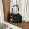 Bolso de mano de color liso para ir al trabajo, nuevo de principios de otoño 2026, bolso tipo cubo casual a la moda, bolso de hombro cruzado simple y elegante