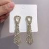 Pendientes largos con diamantes de imitación de estilo europeo y americano de plata 925 con diseño de lazo que combinan con todo, elegantes aretes Han Xue para mujer.