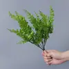 Plantas verdes artificiales en stock, manojos de helecho, hojas de helecho, hierba de helecho para decoración de paredes interiores y diseño de paisajes, césped artificial al por mayor