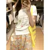 Camiseta de Manga Corta con Hombro Descubierto y Letras Estilo Americano Picante para Mujer, Nuevo Top de Verano 2025 con Diseño Holgado Adelgazante