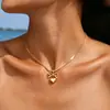 Collar con colgante de lazo y corazón de acero de titanio Dongguan para mujer, colgante de oro de 18 quilates, cadena para la clavícula que no se decolora, venta al por mayor y personalizable