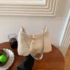 Bolso de axila tejido vintage para mujer, nuevo bolso baguette con cadena de moda 2026, bolso de hombro y cruzado versátil y moderno para el día a día