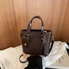 Bolso pequeño súper popular para el trabajo, nuevo modelo de verano 2026 para mujer, bolso cubo de un solo hombro cruzado con patrón tejido de alta gama