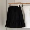 Saia Midi Cáqui Estilo College 2026 Nova Coleção Primavera/Verão Redutora de Idade Estilo Japonês Saia Evasê com Bolsos Coreana