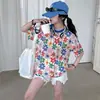 Shorts de Verano para Niñas Conjunto de Dos Piezas Camiseta de Manga Corta Traje Grande Borde Crudo Moda Infantil 2025 Flor Nuevo Verano