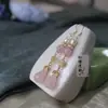 Aretes de cristal rosa natural estilo chino nuevo capullo de flor de magnolia Hanfu estilo antiguo aretes cheongsam clip de oreja con temperamento retro gancho de oreja para mujer