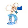 Llavero Colgante Temático Océano Azul con Borla de Estrella de Mar, Llavero de Resina Encanto para Bolso con 26 Letras