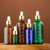 Botella de esencia de vidrio con gotero de cabeza de goma para sub-embotellado de cosméticos oscuros marrones, botella de esencia de vidrio con escala, ventas directas de fábrica