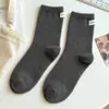 Calcetines de tubo estándar de terciopelo australiano grueso de color liso para otoño e invierno, calcetines peludos para mujer, serie marrón con forro polar estilo ins de Corea del Sur, calcetines de confinamiento