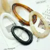 Venta al por mayor del fabricante en stock de hebillas de resina ovaladas con forma de gota de agua para cinturón, hebillas para chaquetas de cuero, hebillas de dos posiciones, hebillas de conexión para trajes de baño, hebillas decorativas