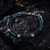 Pulseira de cristal azul-marinho em forma de cruz, de dupla camada, um acessório moderno e versátil para homens e mulheres, adequada para o uso diário e para adicionar um toque de luxo discreto.