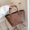 Bolso tejido de verano para mujer 2022, nuevo bolso de moda de gran capacidad para mujer, bolso de paja simple, bolso de cubo portátil