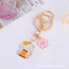 Llavero de gato de la suerte con flor de cerezo estilo japonés, colgante metálico de bendición estilo japonés, venta al por mayor para mochilas de estudiantes y llaveros de coche