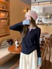 Camiseta de manga larga con diseño de color contrastante para mujer, estilo coreano, con cuello semibierto cepillado y botones en el hombro derecho, para otoño e invierno.