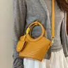 Bolso pequeño tejido con patrón transfronterizo para mujer, nuevo bolso de mano moderno y elegante, bolso tipo cubo con diseño único, bolso de hombro y cruzado de nicho