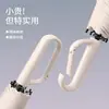 Paraguas creativo con hebilla de anillo de apertura manual al 70% de descuento, protección solar, doble uso para lluvia y sol, paraguas de negocio con recubrimiento negro, sombrilla de estilo japonés simple al por mayor