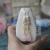 Aretes de cristal rosa natural estilo chino nuevo capullo de flor de magnolia Hanfu estilo antiguo aretes cheongsam clip de oreja con temperamento retro gancho de oreja para mujer