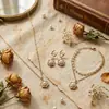 Bestseller de comercio exterior transfronterizo: Conjunto de collar, pulsera y pendientes de moda estilo coreano con colgante de perla y camelia, personalizado, de lujo ligero