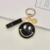 Chaveiro criativo de liga metálica com argila e incrustações de diamantes, face sorridente, expressão sorridente fofa, chaveiro de carro, pingente para bolsa