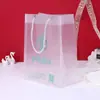 Bolso transparente bolsa de regalo PP esmerilado bolsa de tienda de ropa bolsa para lavar y proteger maquillaje bolsa de embalaje de regalo para manos logotipo personalizado