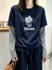 Camiseta Manga Longa Patchwork Listrada Falsa Duas Peças Feminina Outono 2026 Solta Modeladora Senso de Design Camiseta Básica Cartoon