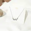 Collar de amor sencillo de estilo japonés y coreano, cadena de clavícula con astas cruzadas, flor, perla y colgante de latido de corazón de celebridad cibernética.